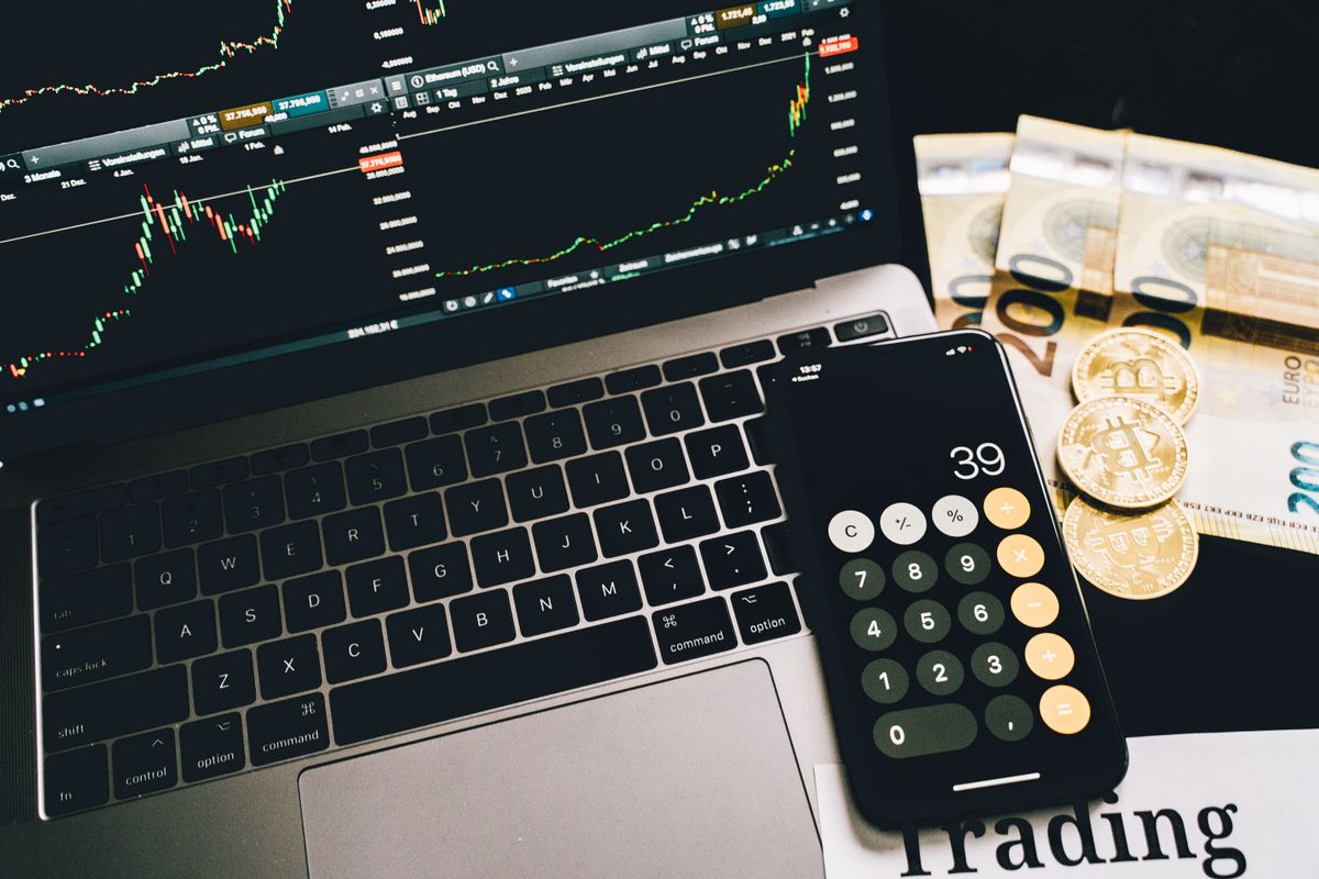 Calculator, laptop financial charts and currency illustrating corporate training budget planning